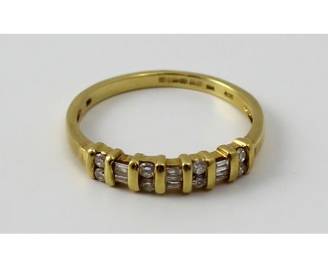 An 18ct yellow gold and diamond ring set with fourteen alternating round and baguette cut stones, size R 1/2, approx 3g.