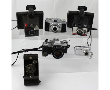 Six cameras; a Polaroid Super Swinger Land Camera, a Polaroid Colour Pack 80, an Enson Greyhound, a Traveler Slimline X5, a C