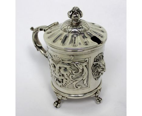 A French silver mustard pot with artichoke finial, lion head decoration to four paw feet, approx 5.5ozt, height 6cm. CONDITIO