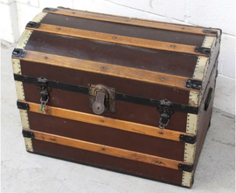 An early 20th century travel trunk with wood and brass band decoration, length 69cm.