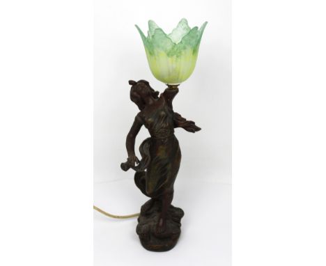 An Art Nouveau spelter lamp, female form on stylised plinth base with a green and yellow mottled glass tulip shade, height 54