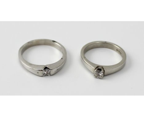 An 18ct white gold and diamond solitaire ring, the round brilliant cut stone approx 0.15ct, size L, and a solitaire ring set 