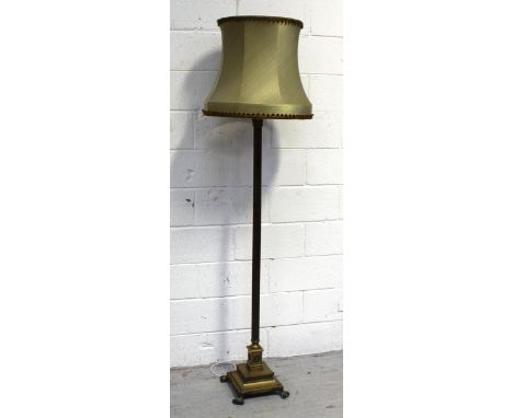 A vintage brass standard lamp, acanthus leaf decoration above a Classical reeded column, to square stepped base to paw feet, 