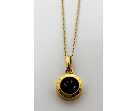 An 18ct gold fine link chain and an 18ct gold pendant in the form of a compass, approx 6.5g.