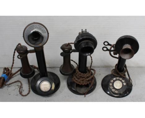 Three vintage black stick telephones with Bakelite microphone covers and levers, in various states of repair, height of large