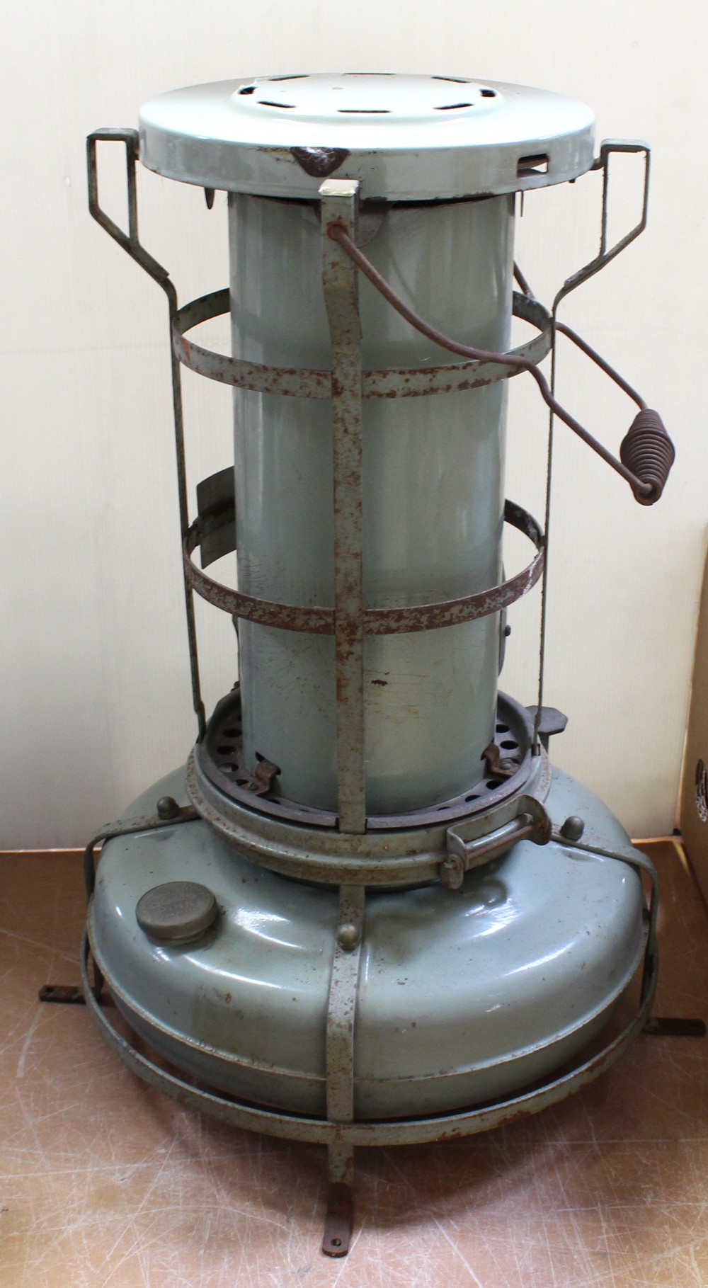 A vintage Aladdin paraffin heater no.H2201 with capped chimney over