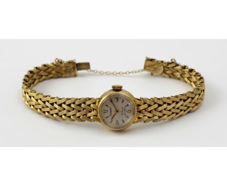 Rotary; a ladies' yellow metal cocktail watch, the silvered dial set with Arabic and Roman numerals, on a yellow metal chevro
