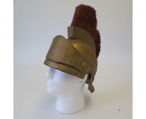 Roman army style movie prop helmet painted in gold with gold hair plume and visor, constructed from metal and wood with "W.C.