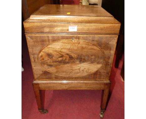 A Regency mahogany hinge top cellarette, having divisional interior brass swing carry handles and raised on square supports t