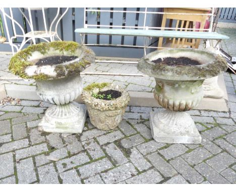 A pair of reconstituted stone pedestal reeded and fluted garden urns, each h.56cm; together with a concrete planter (3)