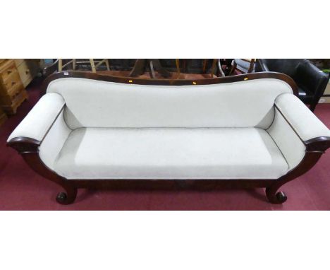 A mid-19th century mahgoany three-seater sofa, pale fabric upholstered, with carved fern leaf detail and raised on scroll end