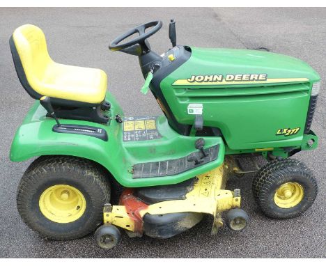 A John Deere LX277 petrol driven tractor mower (with key)Petrol.Width cut 4ft.Runs well &amp; works well.Some welding to cutt