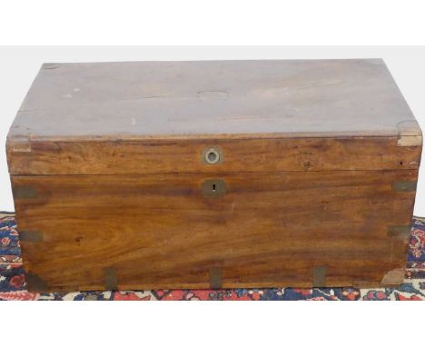 A camphorwood and brass bound hinge top trunk having brass end carry handles, width 88cmSome brasswork missing