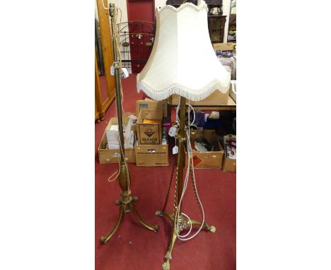 An Art Nouveau floral scroll brass and copper inset standard lamp; together with further brass standard lamp of the period (2