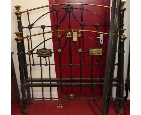 A late Victorian black painted iron and brass three-quarter size bedstead, with iron side rails