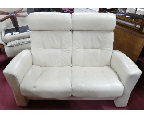 A contemporary cream leather upholstered two-seater sofa, width 143cm