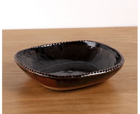 Michael Skipwith (1928-2005) Studio pottery iron glazed dish with crimped rim, impressed marks to the base, 27cm x 26cm x 6.5