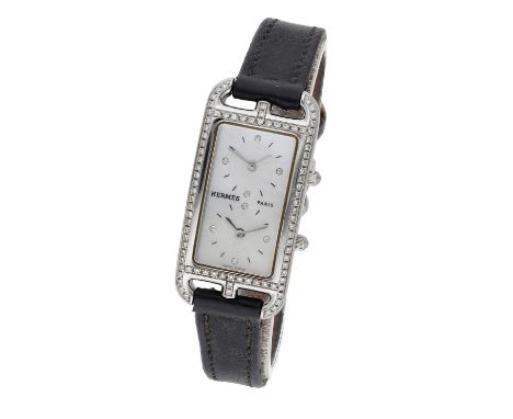 Hermés. A lady’s stainless steel and diamond-set rectangular dual time zone wristwatch with mother-of-pearl dial, Ref. CC3-23