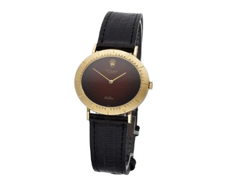 Rolex. A gold oval wristwatch with brown dial, Ref. 4083, Cellini, circa 1973. Movement: cal. 1600, manual winding, 19 jewels