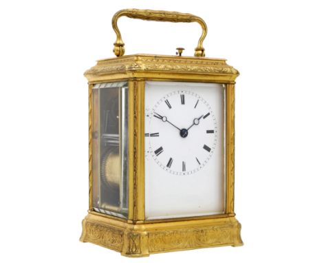A French late 19th century gilt metal carriage clock. Lever escapement, bell strike with push repeat, in a gorge case engrave