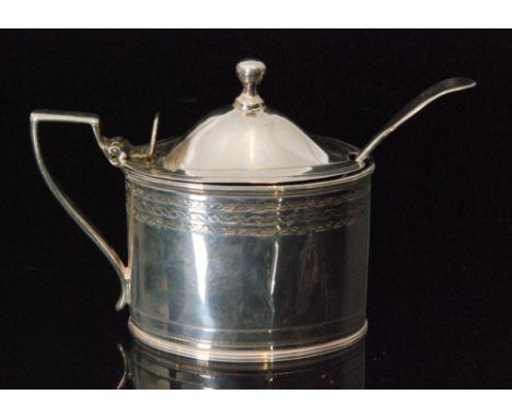 A George III hallmarked silver mustard the oval body with bright cut border decoration, hinged domed cover  and blue glass li