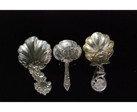 A Victorian hallmarked silver caddy spoon with fluted shell bowl in the Rococo taste below scrolled and floral decorated hand