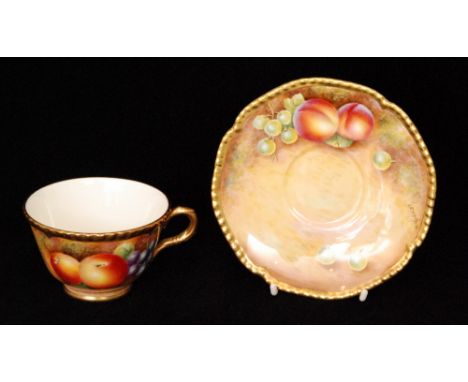 A Royal Worcester Fallen Fruits cabinet teacup and saucer decorated by Leaman with hand painted apples and grapes to the cup 