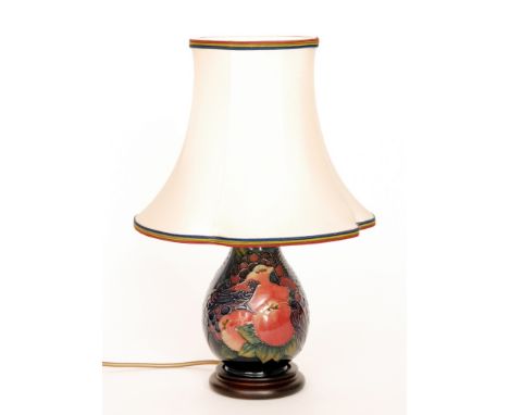 A Moorcroft Pottery table lamp decorated in the Finches pattern, retains original Moorcroft shade, marks obscured by affixed 