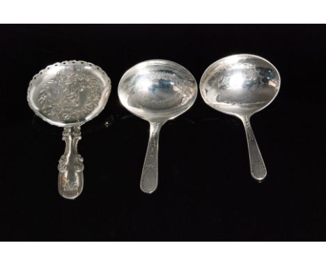 A George III hallmarked silver caddy spoon, oval bowl with embossed decoration of a seated maiden and her dog within a floral
