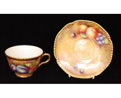 A Royal Worcester Fallen Fruits cabinet teacup and saucer decorated by Leaman with hand painted black peaches and red currant