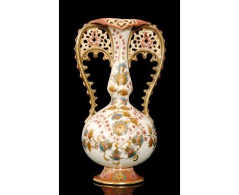 A Zsolnay Pecs twin handled Persian style vase, the footed body of globe and shaft form decorated with sprays of flowers agai