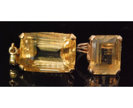 A 14ct citrine ring with large emerald cut claw set stone, rope twist shoulders to plain band, ring size N, stamped and match