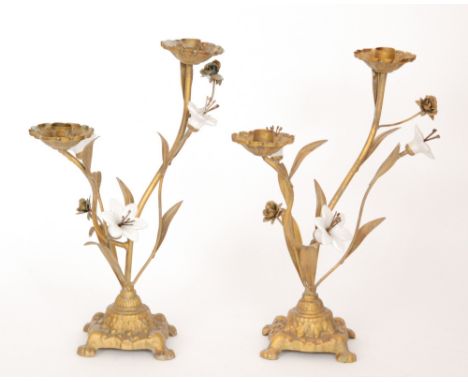 A pair of 19th Century style gilt twin branch candelabra interspaced with white ceramic flower heads on cartouche plinth base