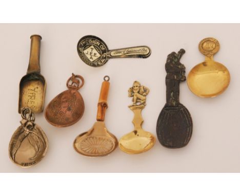 A large selection of novelty caddy spoons to include a brass trench art example, a Scottish 'John E Esslemont Ltd' advertisin