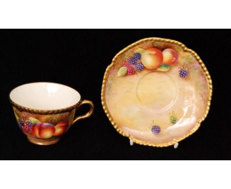 A Royal Worcester Fallen Fruits cabinet teacup and saucer decorated by Leaman with hand painted peaches and blackberries to t