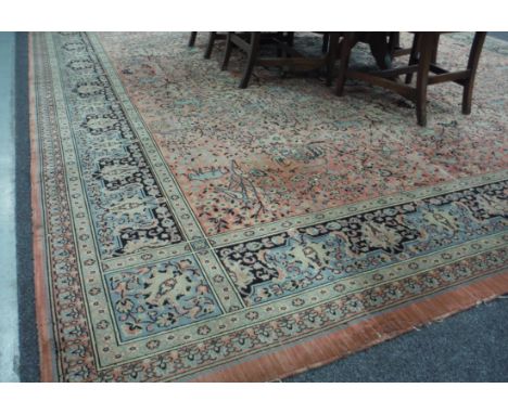 An Axminster style salmon pink Caucasian patterned carpet.