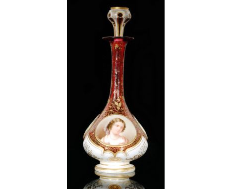 A late 19th Century Bohemian glass scent bottle in the manner of Moser, of footed globe and shaft form cased in opal over rub