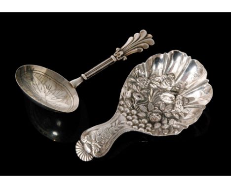 A Wiliam IV hallmarked silver caddy spoon, the fluted bowl with embossed fruit and floral decoration and conforming handle Bi