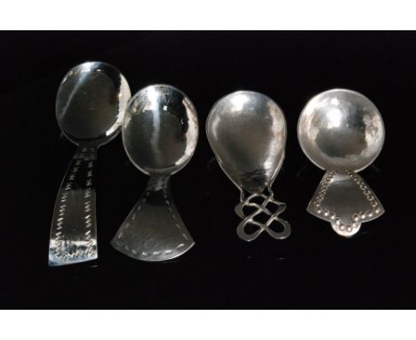 A group of Arts and Crafts Keswick School of Industrial Arts caddy spoons to include a hallmarked silver example with planish