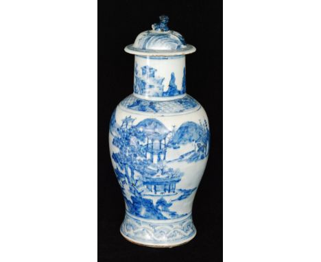 An early 20th Century Chinese blue and white vase and cover decorated in the round with temple buildings and trees against a 