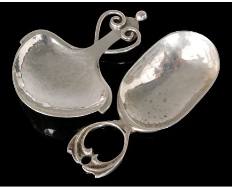 An Arts and Crafts hallmarked silver caddy spoon with planished leaf shaped bowl below scrolled wire heart motif terminal wit