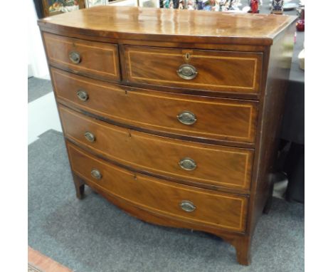 A George III line inlaid mahogany bowfront chest of two short and three long drawers, oval brass drop handles on splayed brac