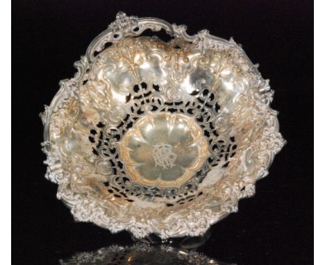 A Victorian hallmarked silver swing handle pedestal basket with pierced and engraved scrolled decoration, weight 22oz, diamet