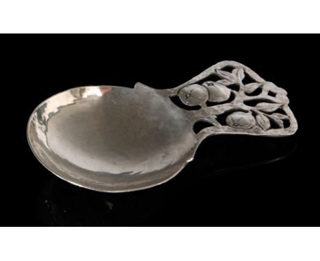 An Arts and Crafts hallmarked silver caddy spoon, the hammered circular bowl below a pierced handle with fruiting apple tree 