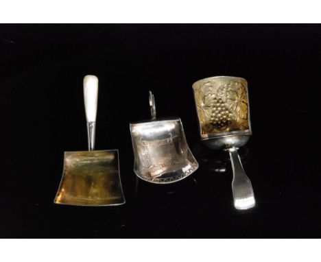 A George III hallmarked silver shovel shaped caddy spoon with bright cut decoration and wirework loop handle, Birmingham 1806