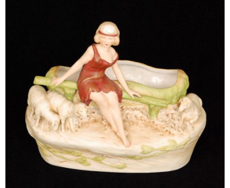 A Royal Dux Bohemia planter modelled as a scantily clad lady sat on a bench with sheep by her side, applied pink triangle mar