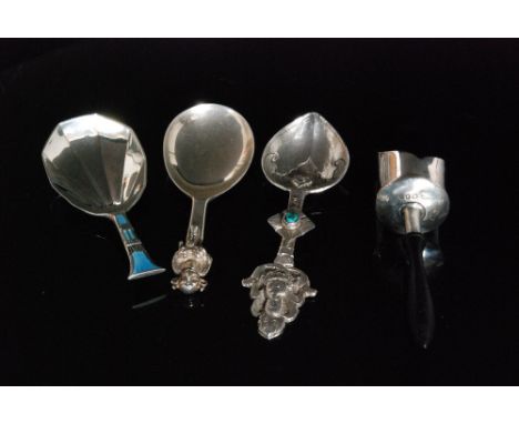 A hallmarked silver scoop shaped caddy spoon with turned wooden ebonised handle, London 1925, makers mark rubbed, together wi