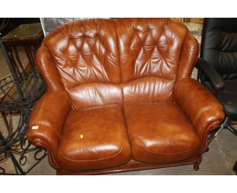 A BROWN LEATHER TWO SEATER SOFA