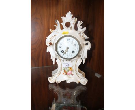 A CERAMIC MANTLE CLOCK WITH FRENCH MOVEMENT