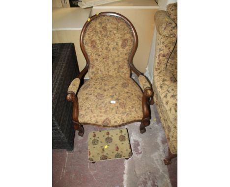 AN UPHOLSTERED SPOONBACK ARMCHAIR TOGETHER WITH A STOOL